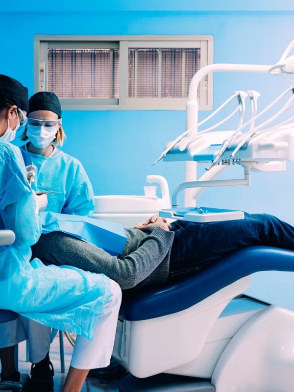 dentists-with-a-patient-during-a-dental-interventi-2021-08-27-22-49-33-utc-min.jpg